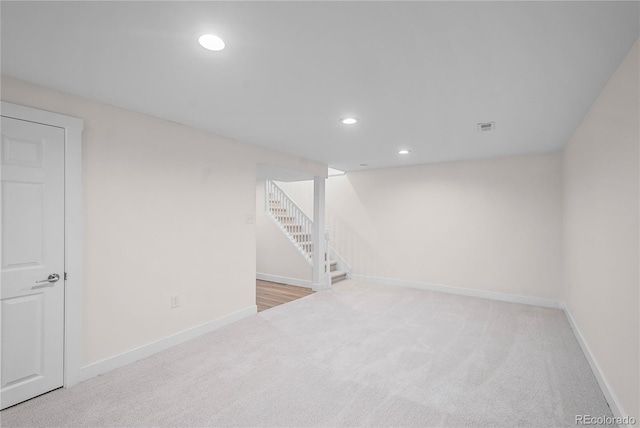 basement featuring light carpet