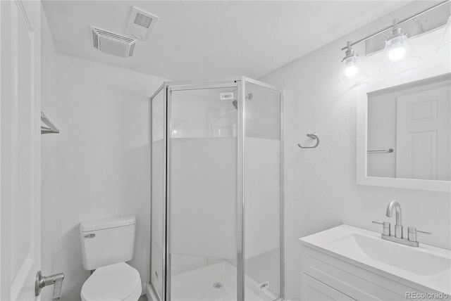 bathroom with toilet, walk in shower, and vanity