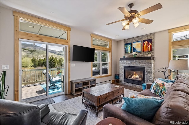133 Creek Ln, Silverthorne, CO 80498 - living area with wood finished floors, a stone fireplace, ceiling fan, baseboard heating, and recessed lighting
