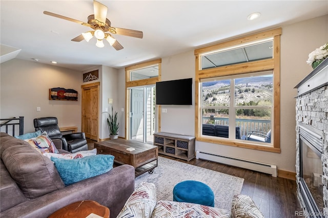133 Creek Ln, Silverthorne, CO 80498 - living area featuring baseboard heating, wood finished floors, a stone fireplace, a ceiling fan, and recessed lighting