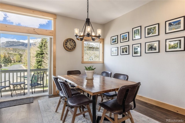 133 Creek Ln, Silverthorne, CO 80498 - dining area featuring wood-type flooring, a chandelier, and a mountain view