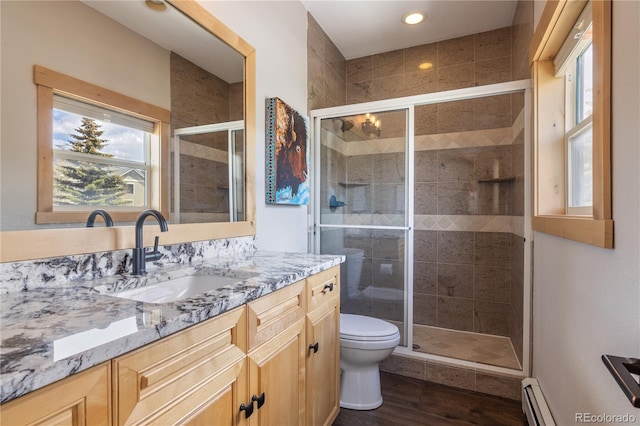 133 Creek Ln, Silverthorne, CO 80498 - bathroom featuring a baseboard heating unit, vanity, wood finished floors, a shower stall, and recessed lighting