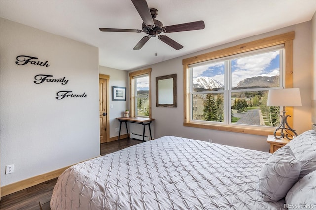 133 Creek Ln, Silverthorne, CO 80498 - bedroom featuring baseboard heating, dark wood-style floors, and a ceiling fan