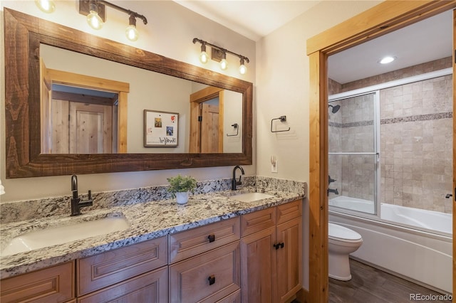 133 Creek Ln, Silverthorne, CO 80498 - bathroom featuring double vanity, shower / bath combination with glass door, and wood finished floors
