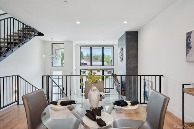 dining area featuring a notable chandelier and light hardwood / wood-style flooring