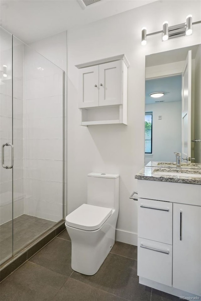 bathroom featuring walk in shower, vanity, toilet, and tile floors