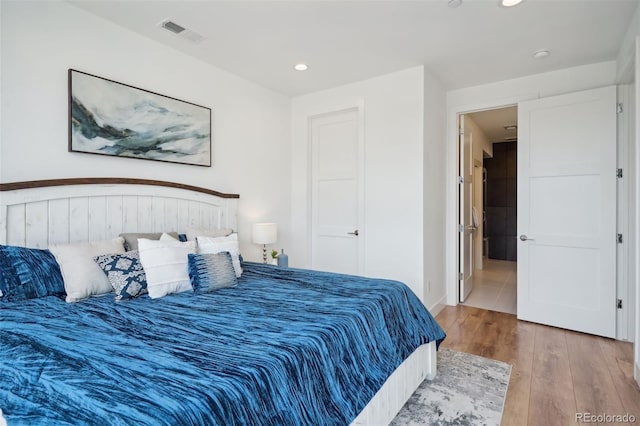 bedroom with hardwood / wood-style floors