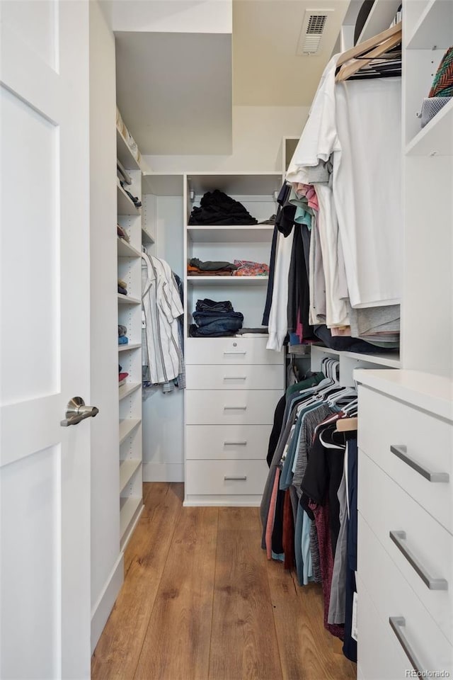 walk in closet featuring light hardwood / wood-style floors