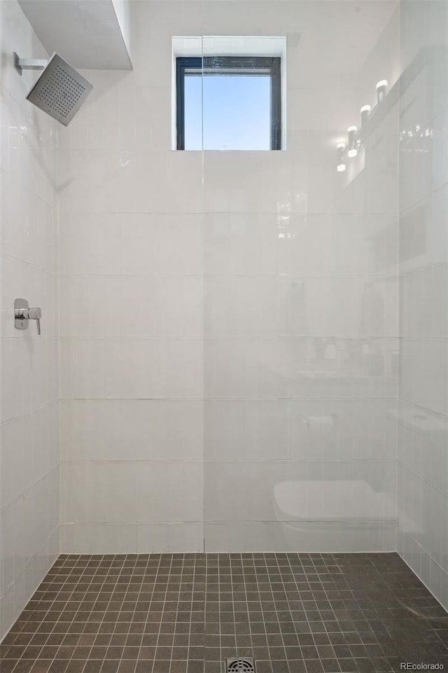 bathroom with tiled shower