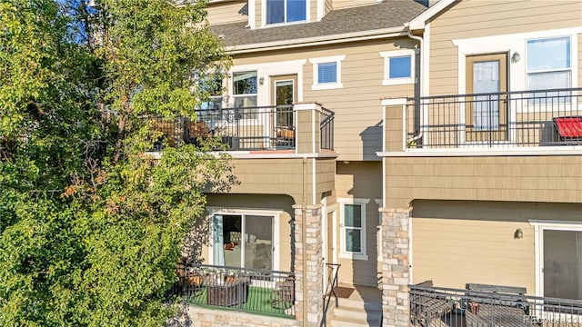 rear view of house featuring a balcony