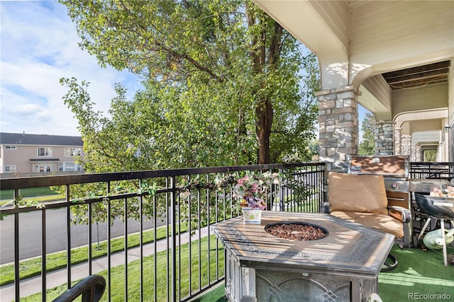 balcony featuring an outdoor fire pit