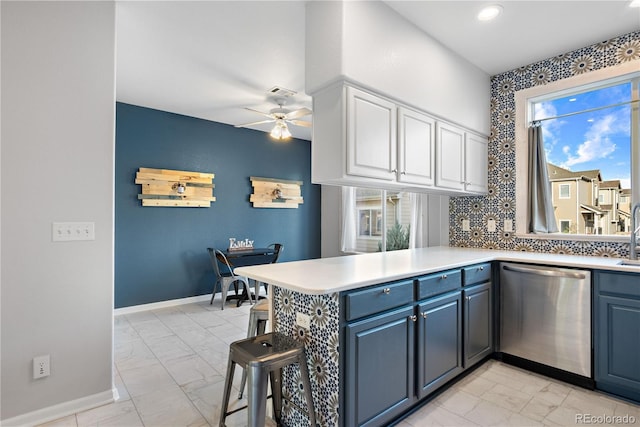 kitchen with dishwasher, kitchen peninsula, white cabinetry, and a healthy amount of sunlight