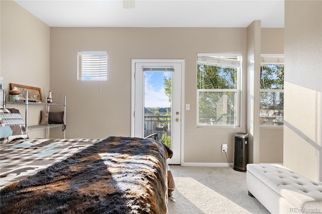 carpeted bedroom featuring access to outside and ceiling fan