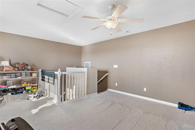 interior space with ceiling fan and carpet flooring