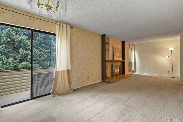 unfurnished living room featuring carpet flooring and a textured ceiling