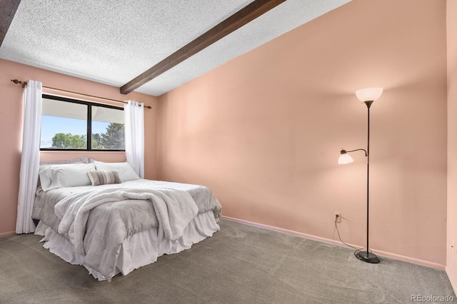 bedroom featuring carpet, vaulted ceiling with beams, and a textured ceiling