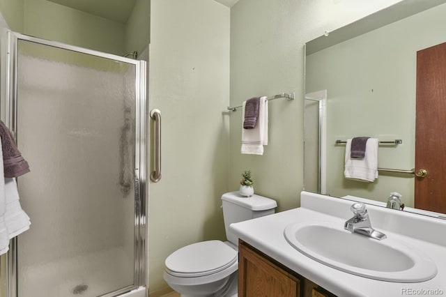 bathroom with vanity, toilet, and an enclosed shower