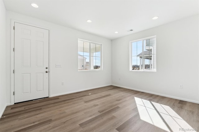 interior space with recessed lighting, visible vents, plenty of natural light, and wood finished floors