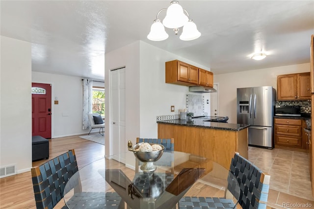 5593 E Center Ave, Denver, CO 80246 - dining room with a chandelier, baseboards, and light wood-type flooring
