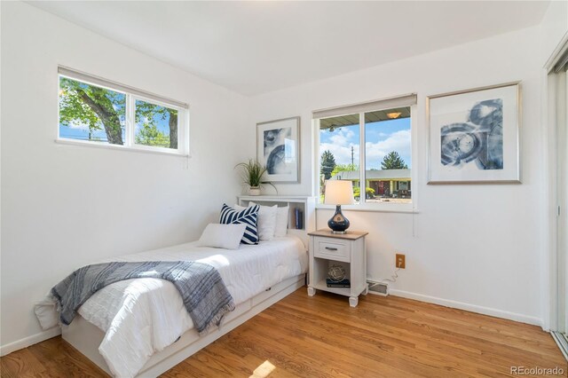 5593 E Center Ave, Denver, CO 80246 - bedroom with light wood-style floors and baseboards