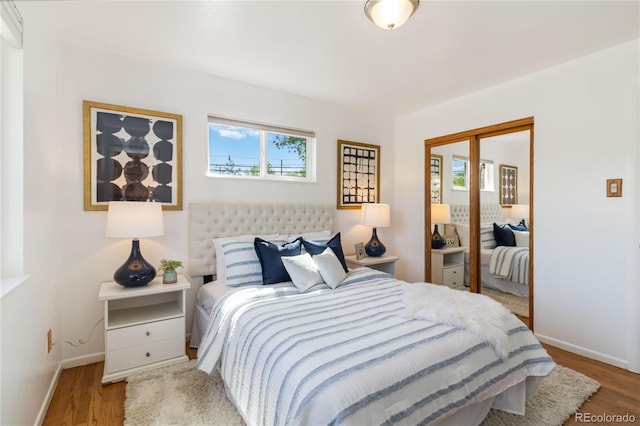 5593 E Center Ave, Denver, CO 80246 - bedroom featuring baseboards, wood finished floors, and a closet
