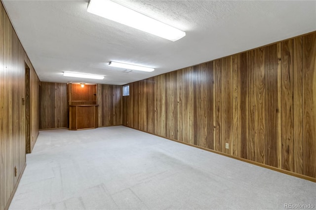 5593 E Center Ave, Denver, CO 80246 - finished basement featuring wood walls, light carpet, and a textured ceiling