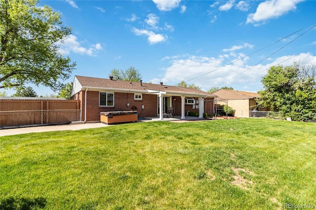 5593 E Center Ave, Denver, CO 80246 - rear view of house featuring a hot tub, a patio, and brick siding