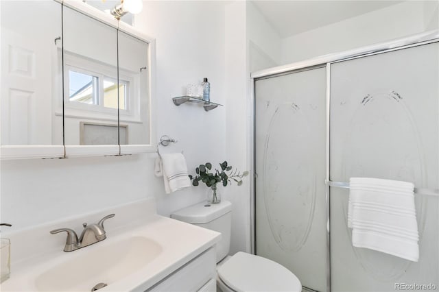 5593 E Center Ave, Denver, CO 80246 - bathroom featuring vanity, toilet, and a shower stall
