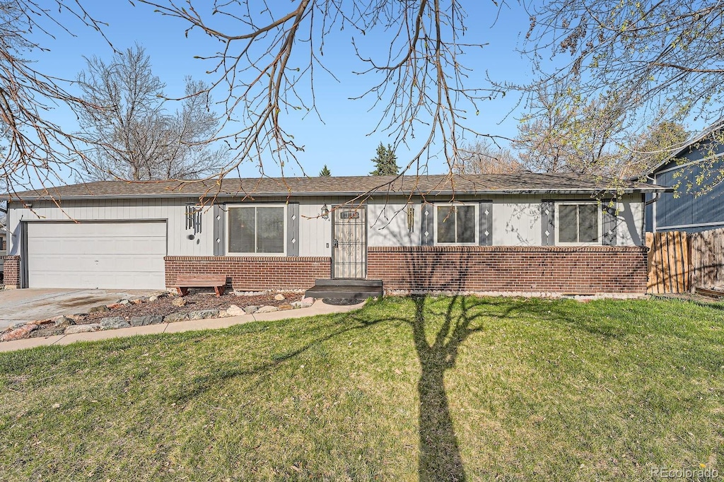 2904 S Idalia St, Aurora, CO 80013 - ranch-style house featuring concrete driveway, brick siding, an attached garage, and a front yard