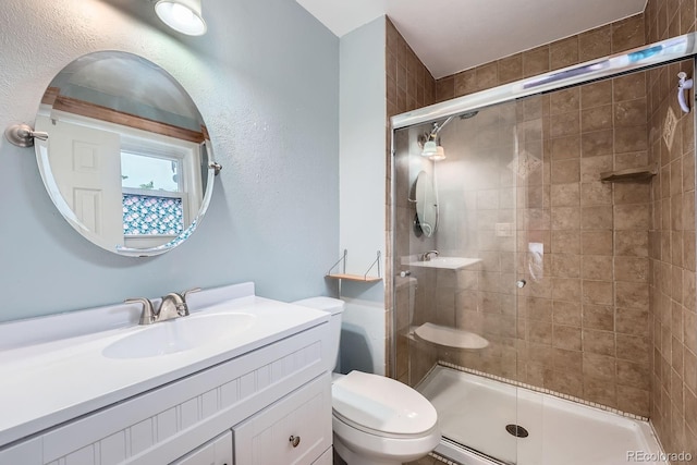 bathroom featuring vanity, toilet, and a shower stall