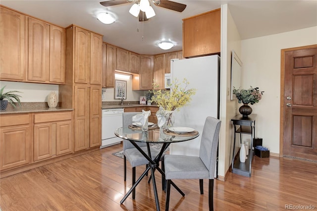 dining space with light wood finished floors, ceiling fan, and baseboards