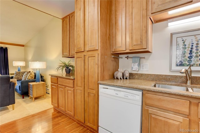 kitchen with dishwasher, a sink, light wood-style floors, vaulted ceiling, and open floor plan