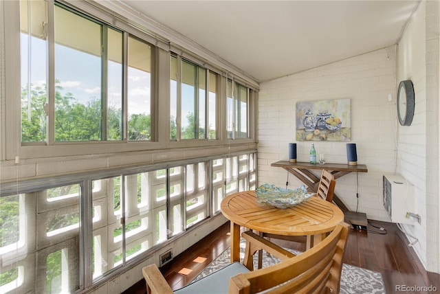 sunroom / solarium featuring vaulted ceiling and heating unit