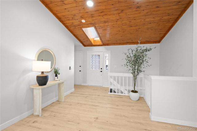 entryway with light wood-type flooring, vaulted ceiling with skylight, and wood ceiling