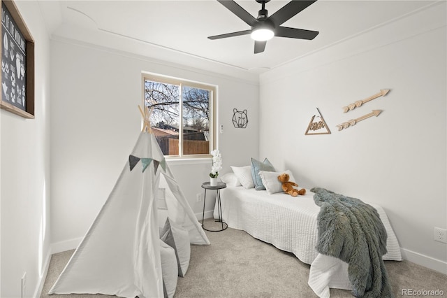 bedroom with light colored carpet, ceiling fan, and crown molding