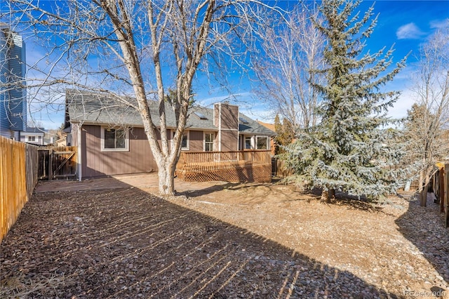 rear view of house featuring a wooden deck