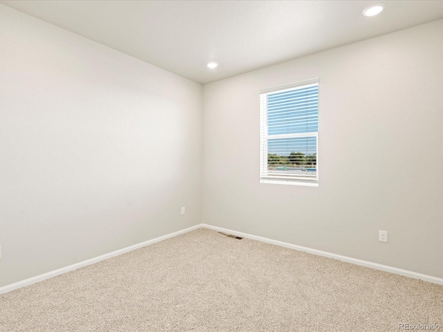 spare room featuring baseboards, carpet flooring, and recessed lighting