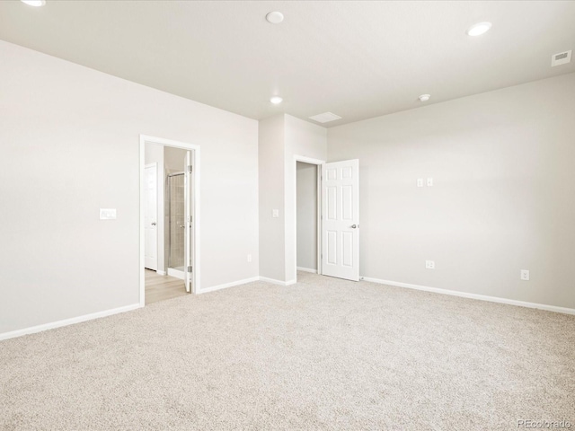 interior space featuring recessed lighting, light carpet, and baseboards