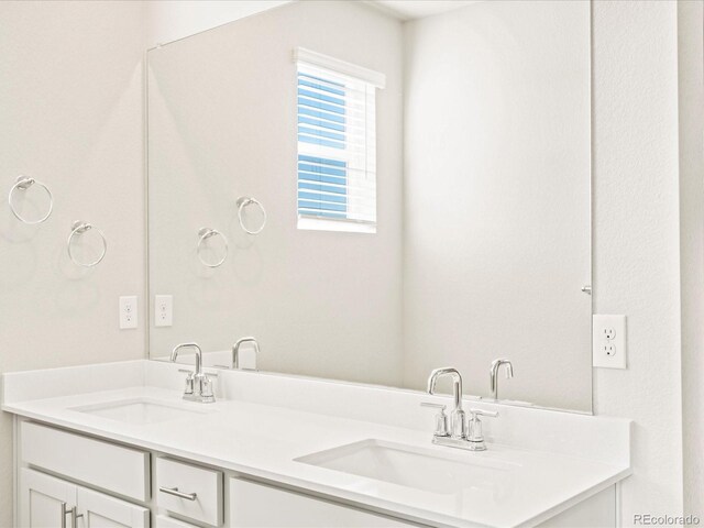 full bath with a sink and double vanity