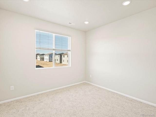 spare room featuring baseboards, visible vents, recessed lighting, and carpet flooring