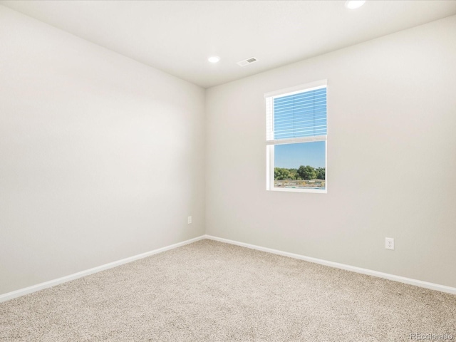 unfurnished room with baseboards, carpet floors, visible vents, and recessed lighting