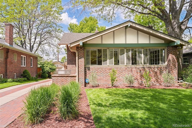 1767 S Sherman St, Denver, CO 80210 - view of front of property featuring brick siding and a front yard