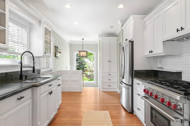 1767 S Sherman St, Denver, CO 80210 - kitchen featuring stainless steel appliances, a sink, decorative backsplash, white cabinets, and ornamental molding