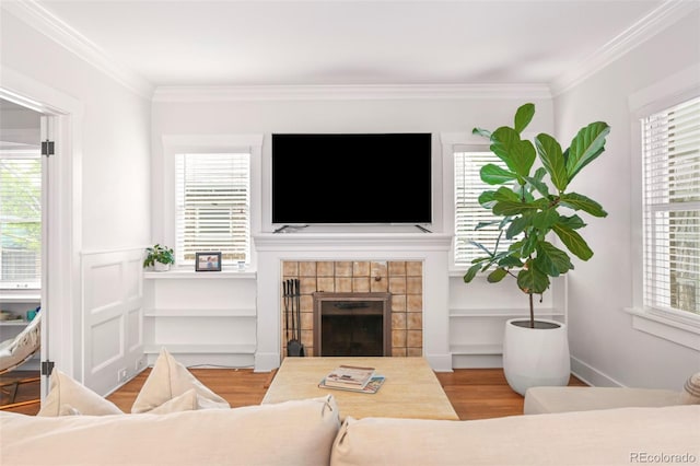 1767 S Sherman St, Denver, CO 80210 - living room with wood finished floors, crown molding, a tiled fireplace, and plenty of natural light