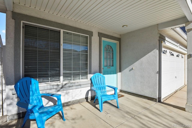 view of patio / terrace featuring a garage