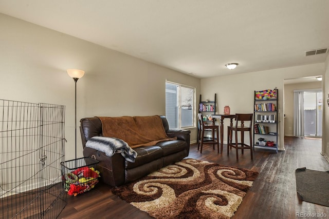 living room with dark hardwood / wood-style flooring