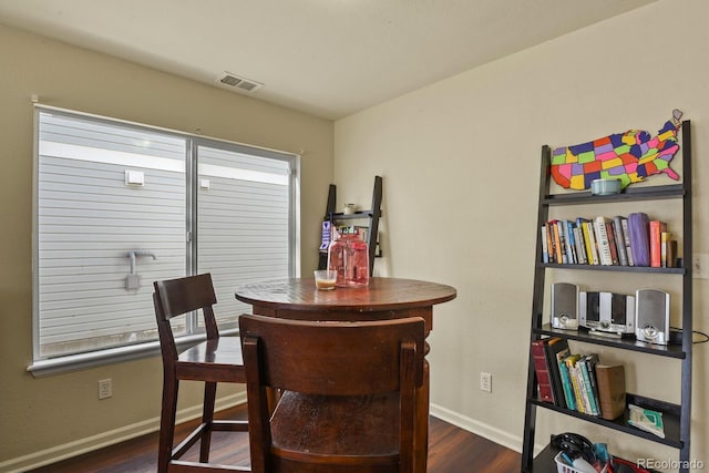 dining area featuring dark wood-type flooring