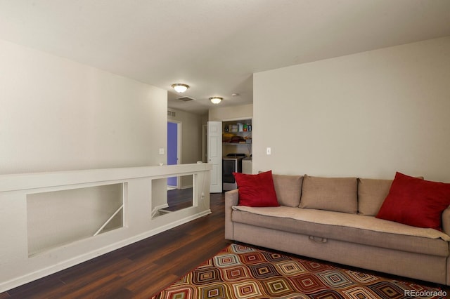 living room with separate washer and dryer and wood-type flooring