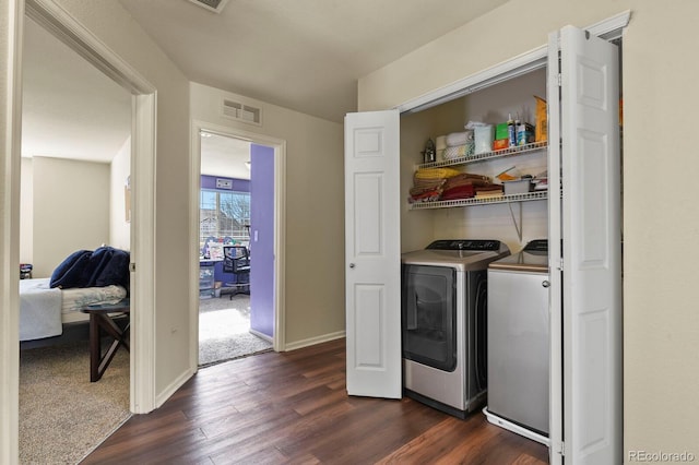 washroom with dark hardwood / wood-style flooring and independent washer and dryer