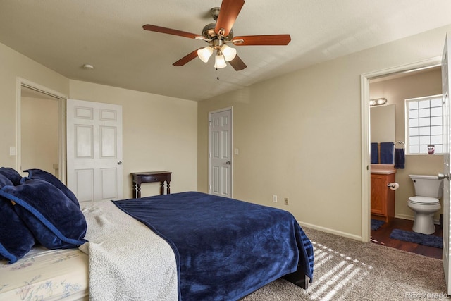 bedroom with ceiling fan, carpet floors, and ensuite bath